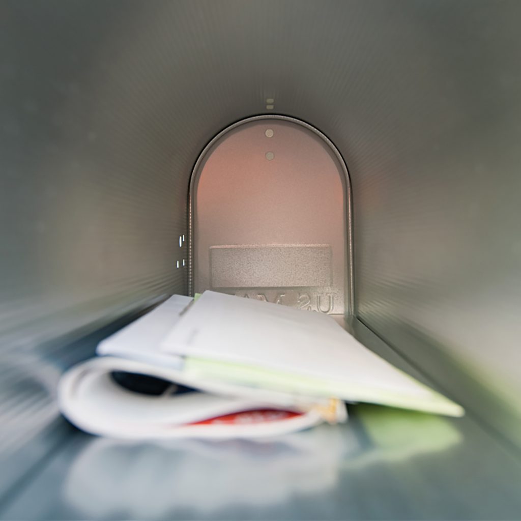 The inside of a mailbox, with a few items of mail in it.